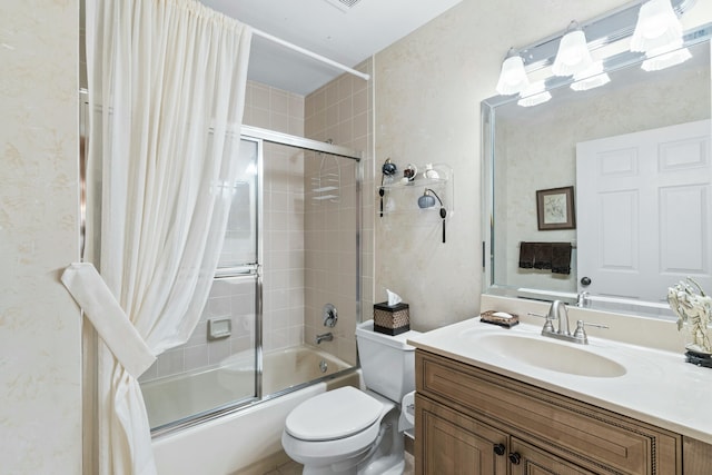 full bathroom with vanity, bath / shower combo with glass door, and toilet