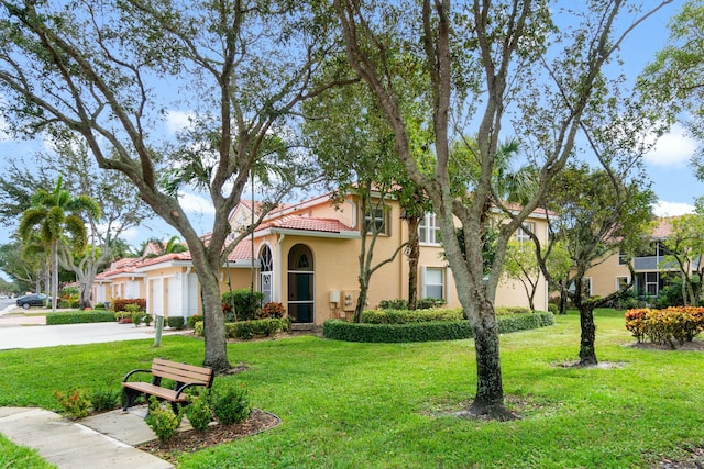 view of front of home featuring a front yard and a garage