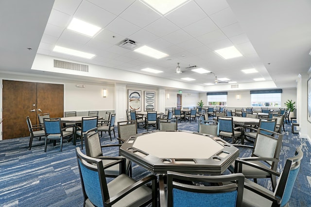 dining area featuring a paneled ceiling, ceiling fan, and carpet floors