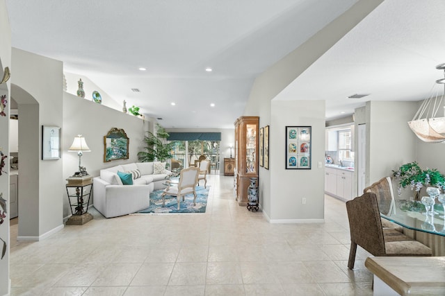 tiled living room featuring lofted ceiling