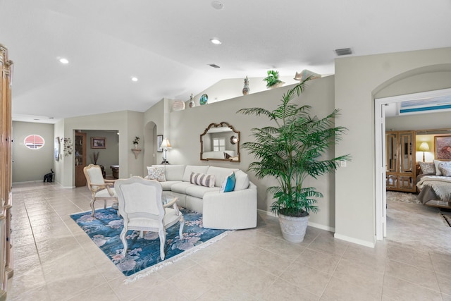 tiled living room featuring vaulted ceiling