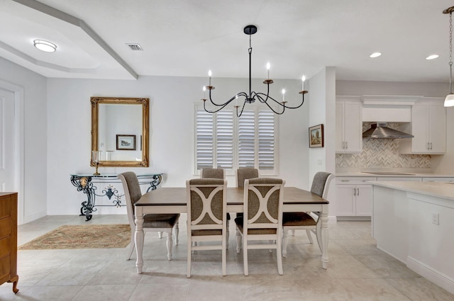 tiled dining space with an inviting chandelier