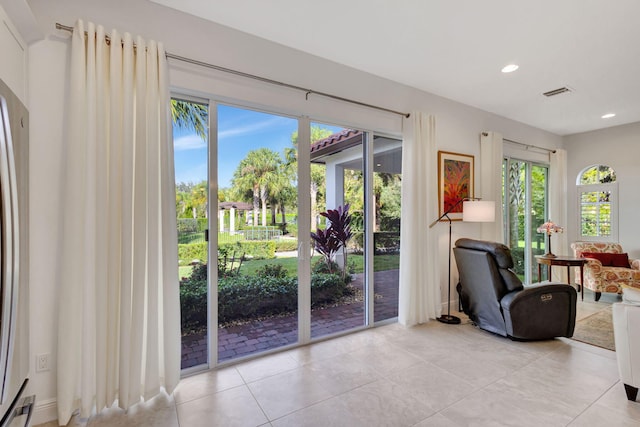 doorway to outside with light tile patterned floors