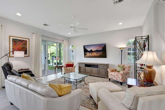 tiled living room with ceiling fan