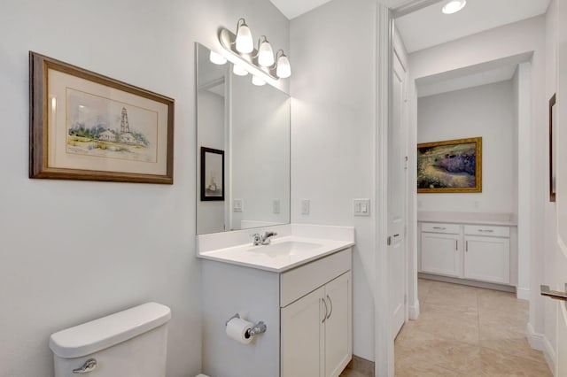 bathroom with tile patterned floors, vanity, and toilet