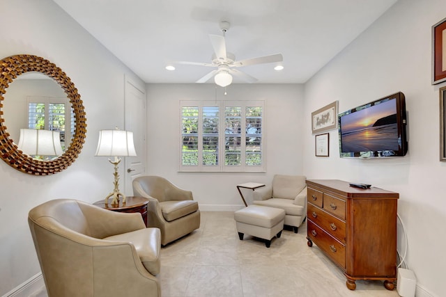 sitting room featuring ceiling fan