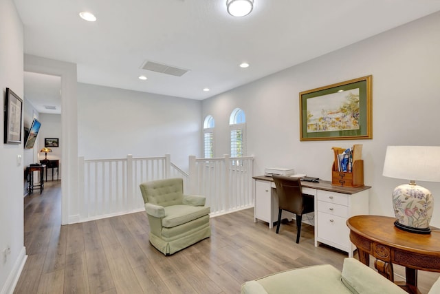 home office with light hardwood / wood-style floors