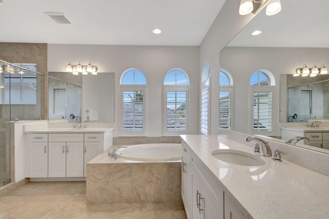 bathroom featuring tile patterned flooring, vanity, and shower with separate bathtub