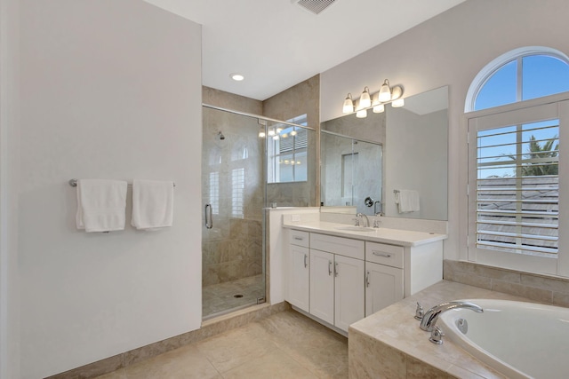 bathroom featuring tile patterned floors, vanity, and shower with separate bathtub