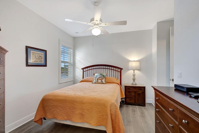 bedroom with ceiling fan and light hardwood / wood-style floors