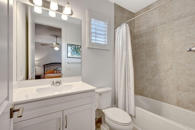 full bathroom featuring ceiling fan, shower / tub combo with curtain, vanity, and toilet