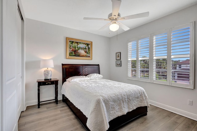 bedroom featuring a closet, light hardwood / wood-style flooring, and ceiling fan