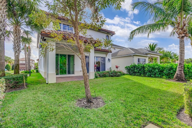 rear view of property with a yard