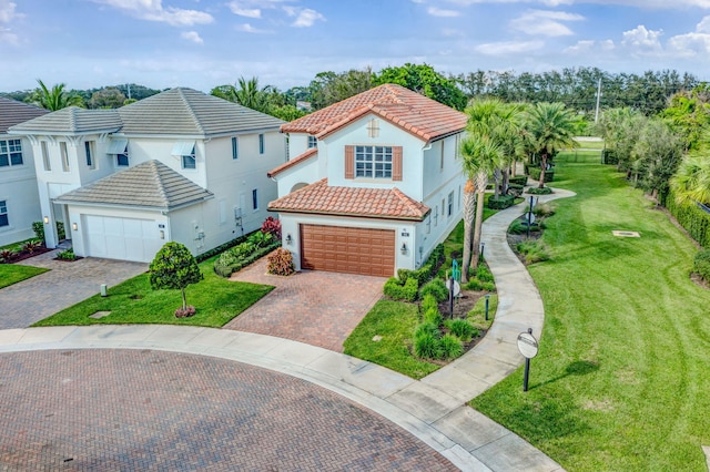 view of front of house featuring a garage and a front lawn