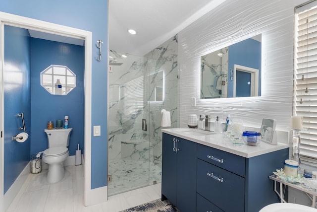 bathroom with vanity, toilet, and a shower with shower door