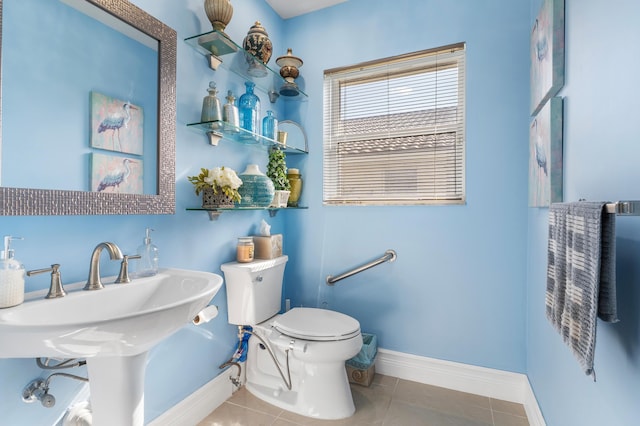 bathroom featuring toilet and tile patterned floors