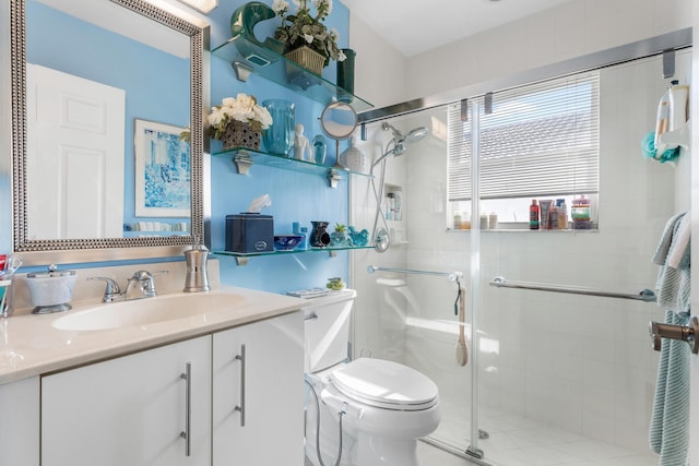 bathroom with vanity, toilet, and a shower with door