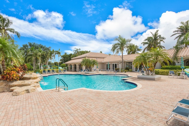 view of pool featuring pool water feature and a patio area