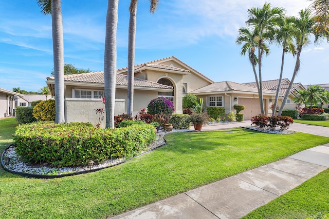 view of front of home featuring a garage and a front lawn