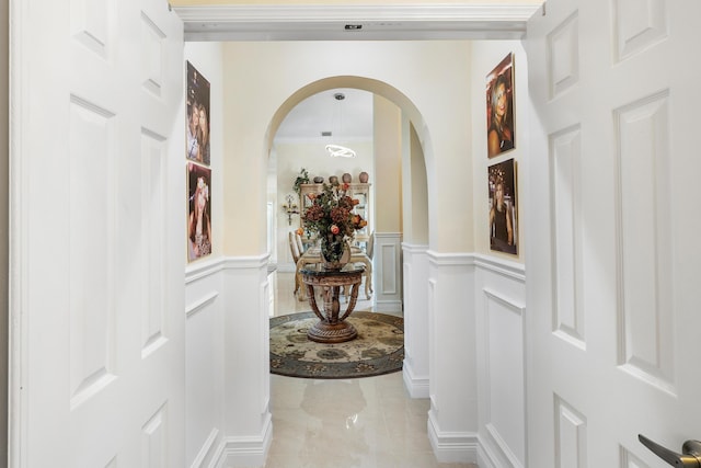 hallway featuring ornamental molding