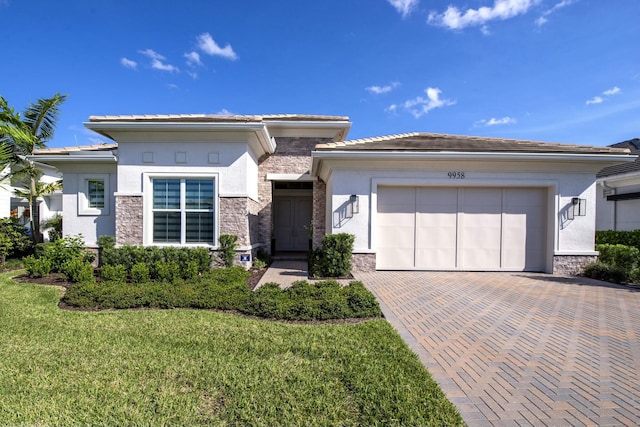 prairie-style home with a garage and a front yard