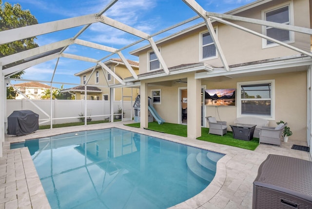 view of pool with area for grilling, a lanai, and a patio area