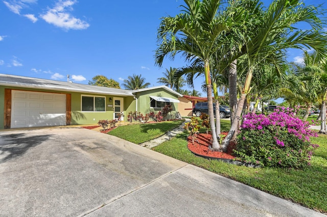 ranch-style house with a front yard and a garage