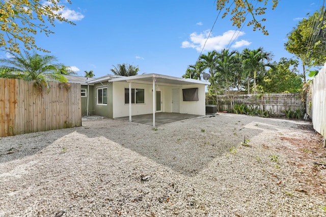 rear view of property featuring cooling unit and a patio area