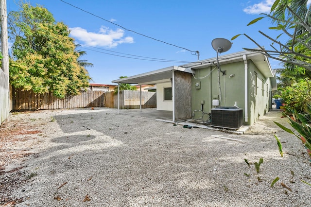 rear view of property featuring central air condition unit and a patio