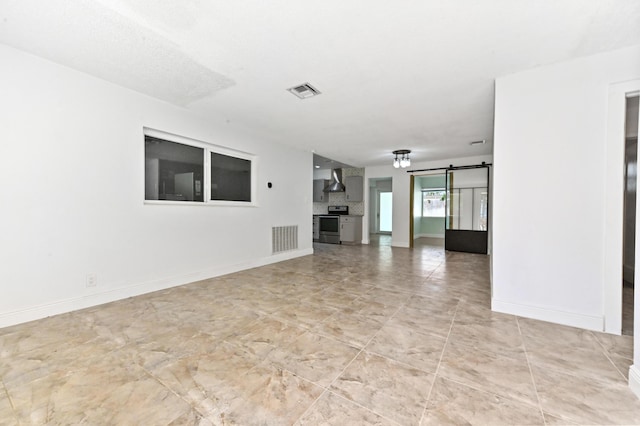 unfurnished living room with a barn door