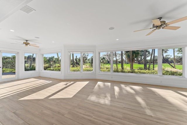 unfurnished sunroom with ceiling fan