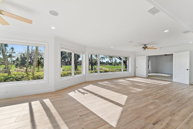 unfurnished sunroom featuring ceiling fan