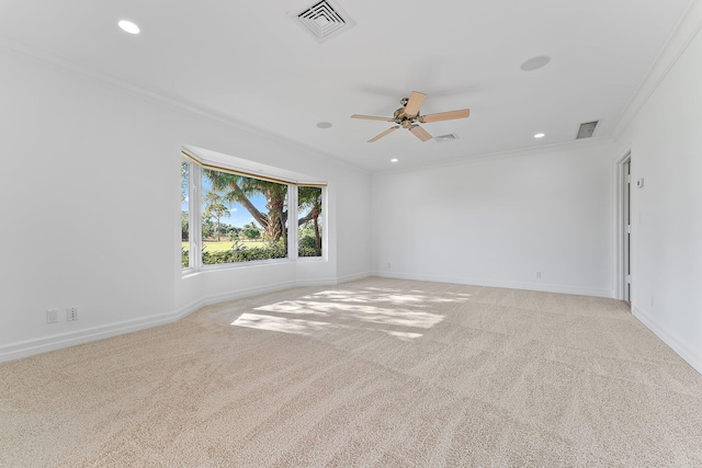 carpeted empty room featuring ceiling fan and crown molding