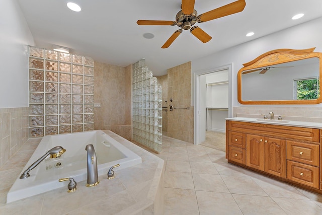 bathroom with vanity, ceiling fan, tile walls, independent shower and bath, and tile patterned flooring