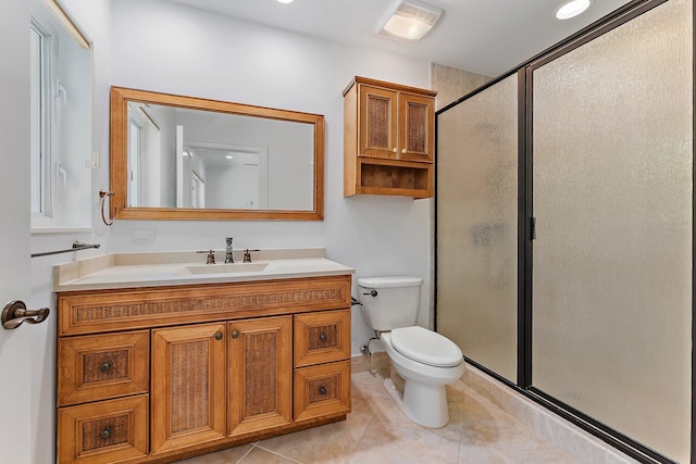 bathroom featuring tile patterned floors, vanity, toilet, and an enclosed shower