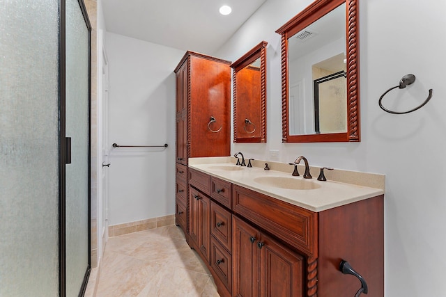 bathroom featuring tile patterned flooring, vanity, and walk in shower