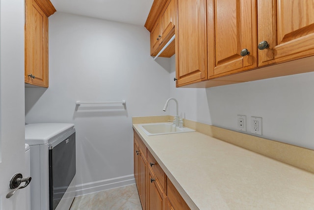 washroom with sink, light tile patterned floors, and cabinets