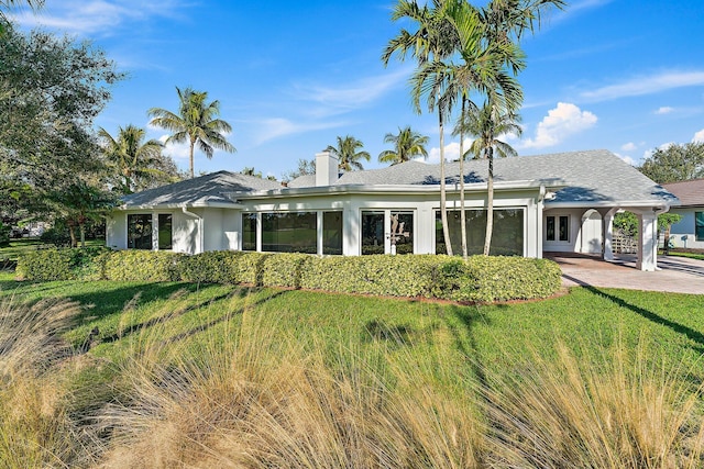 back of house featuring a yard