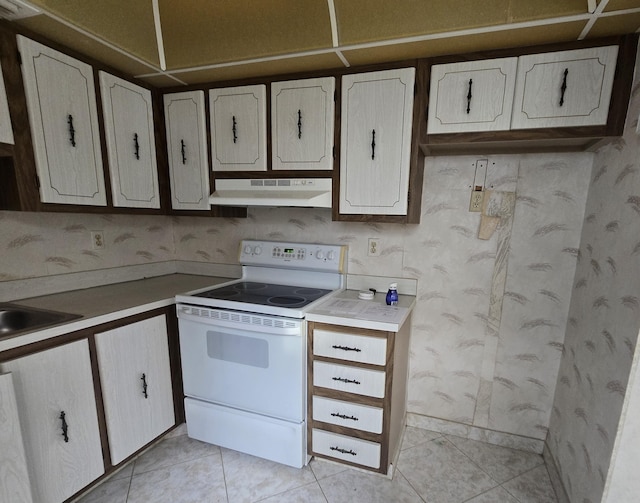 kitchen with white cabinetry, white electric range, sink, and light tile patterned floors