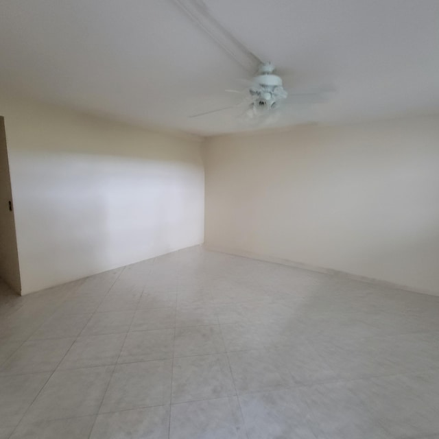 unfurnished room with ceiling fan and light tile patterned flooring