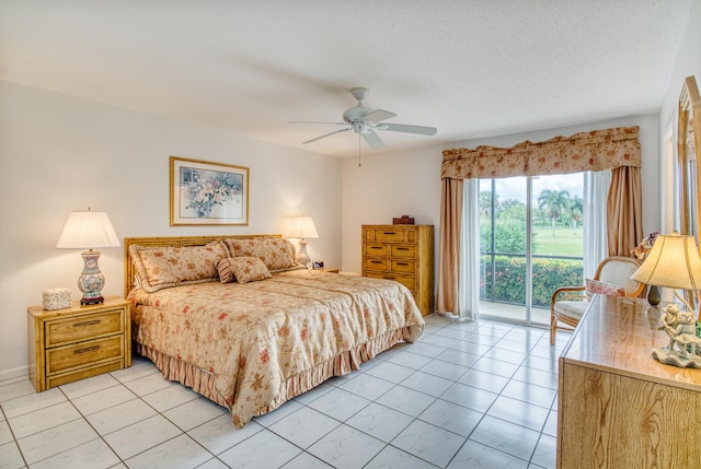 tiled bedroom with ceiling fan, a textured ceiling, and access to outside