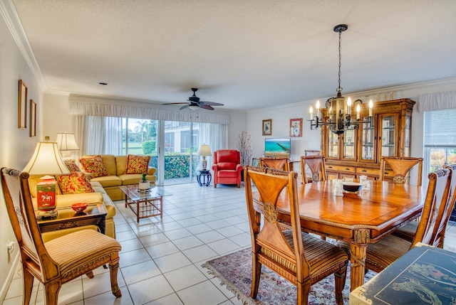 tiled dining room featuring a textured ceiling, crown molding, and ceiling fan with notable chandelier