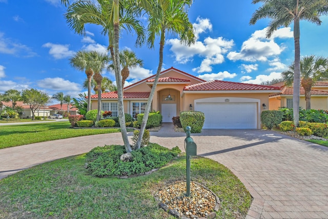 mediterranean / spanish-style house with a front yard and a garage