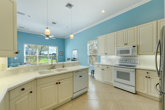 kitchen with ceiling fan, sink, hanging light fixtures, white appliances, and decorative backsplash