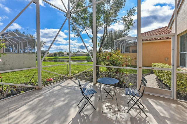 unfurnished sunroom with a water view