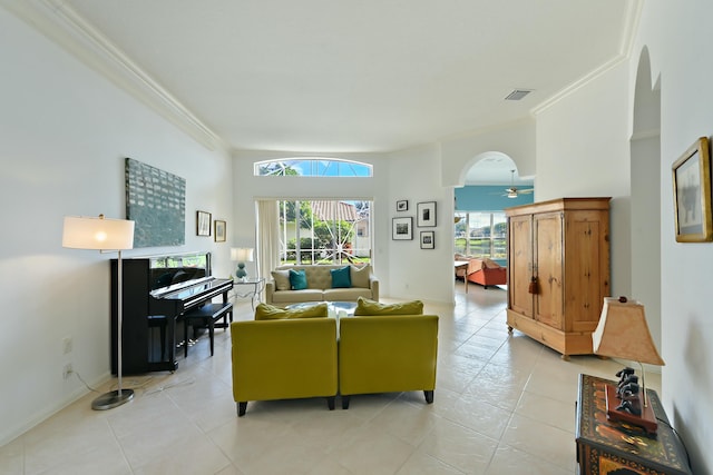 living room with light tile patterned floors, ceiling fan, and ornamental molding