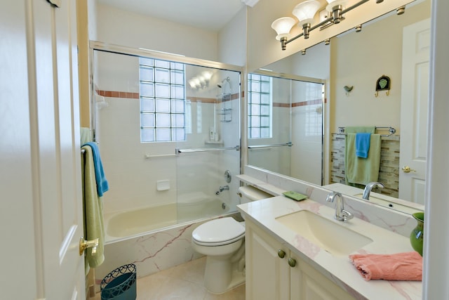 full bathroom with tile patterned flooring, vanity, toilet, and bath / shower combo with glass door