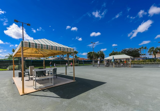 view of property's community with a gazebo and tennis court