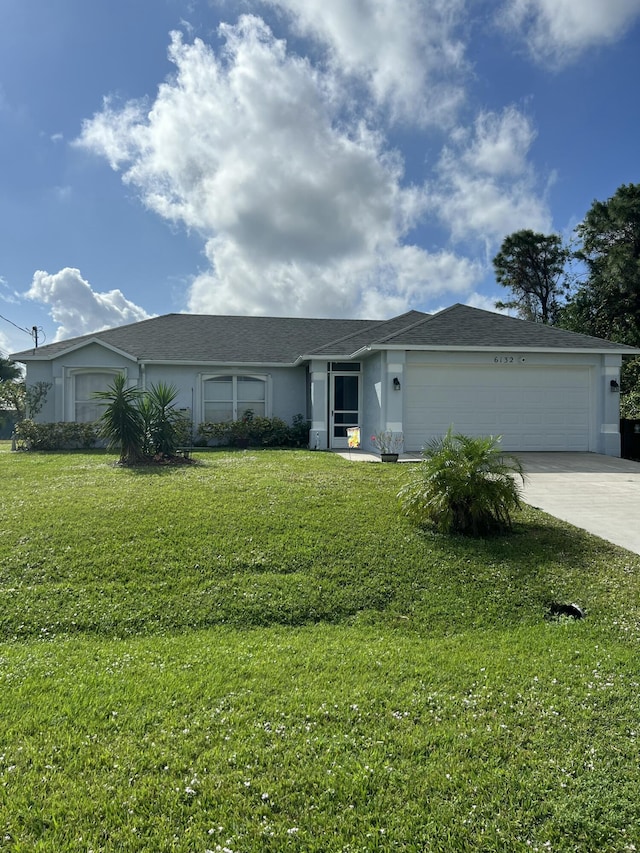 ranch-style home with a garage and a front lawn