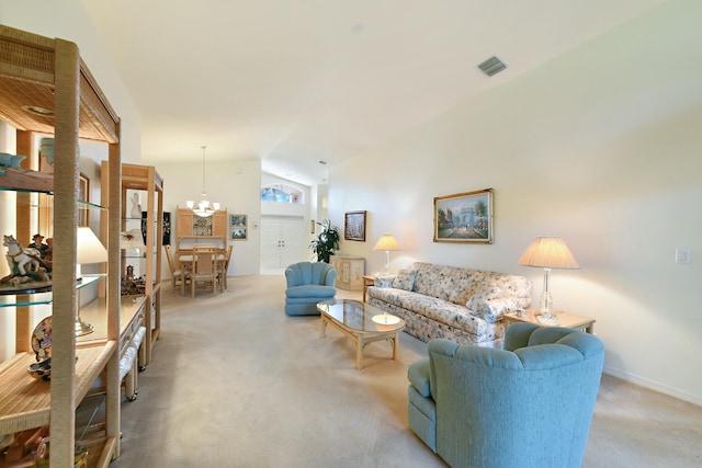 carpeted living room with a chandelier and lofted ceiling